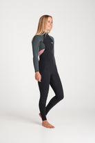 Beth wearing a black and forest green wetsuit on a white background